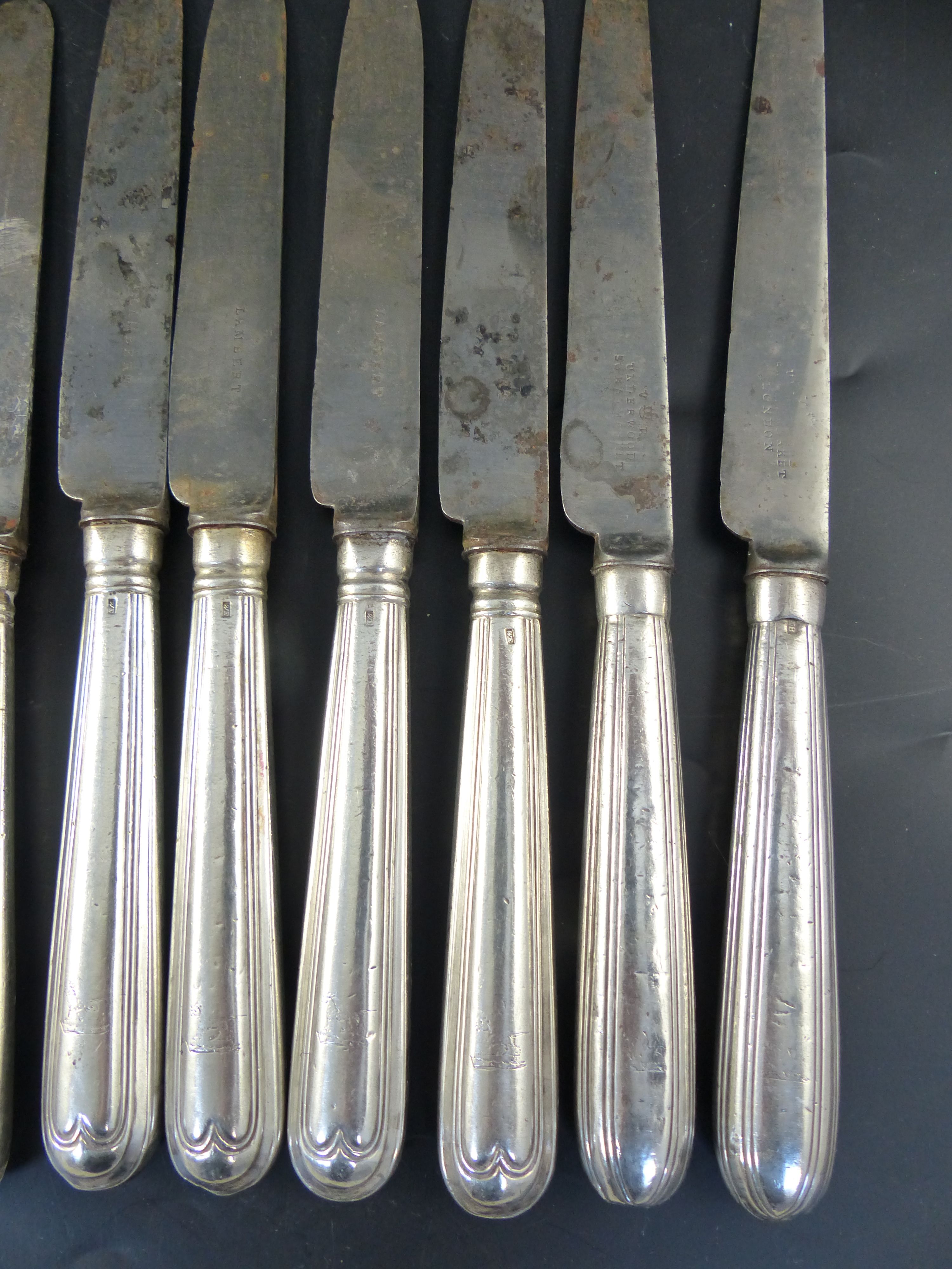 A set of twelve George IV silver handled thread pattern table knives,